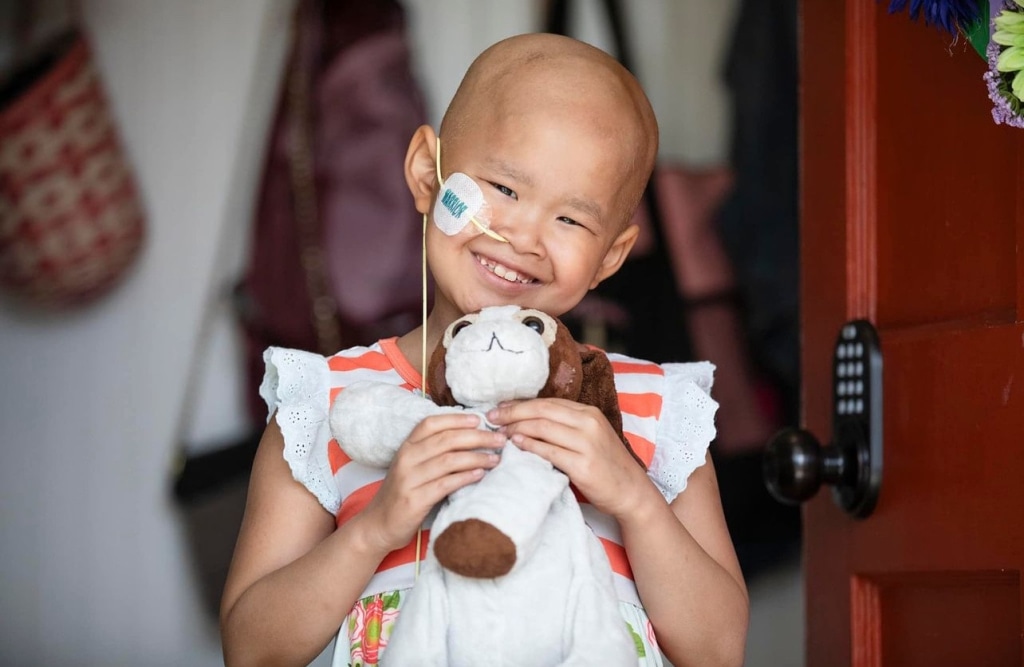 a child holding a stuffed animal