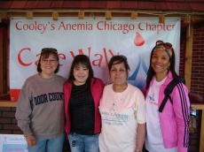 a group of women standing in front of a banner