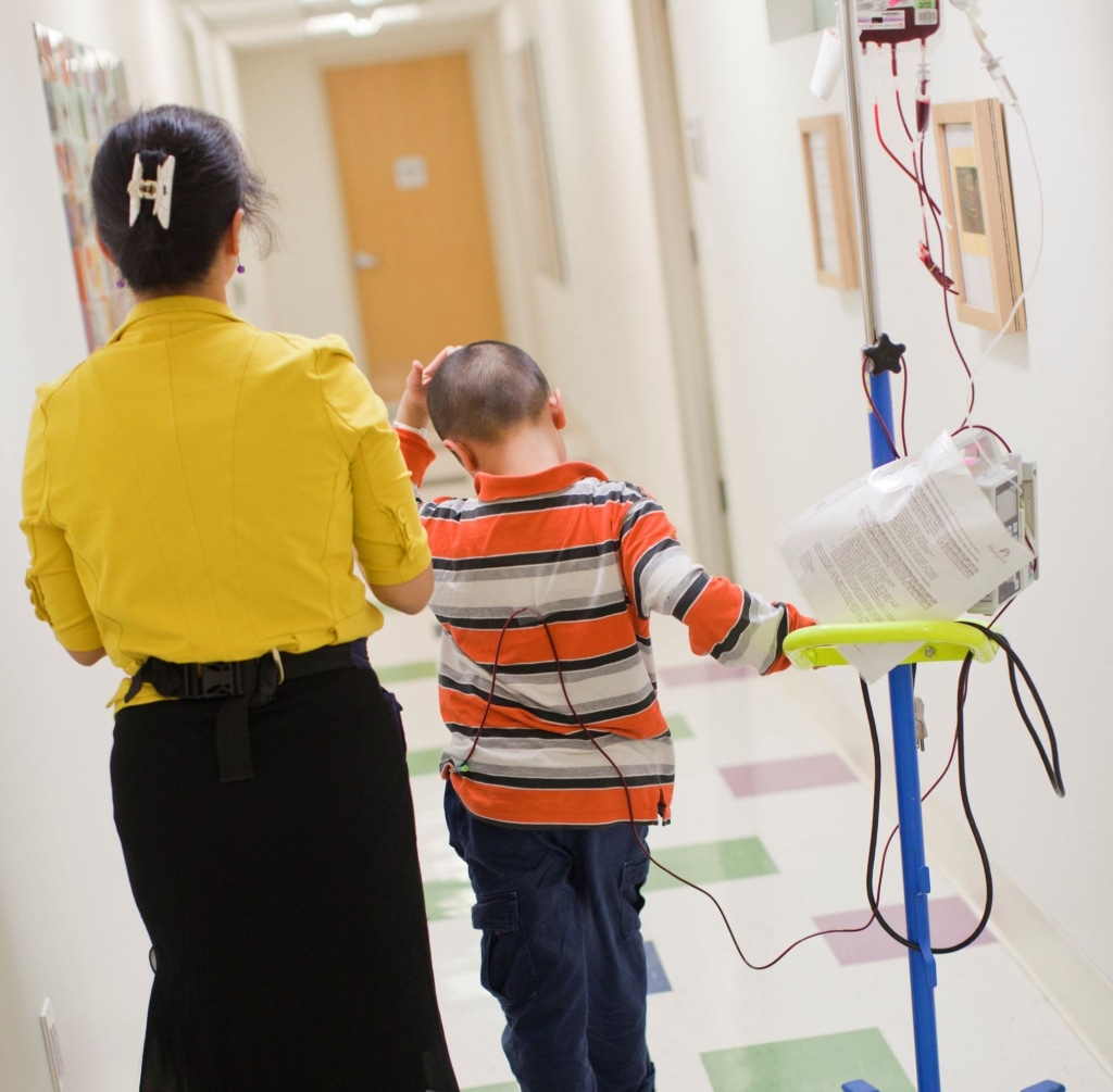 a person and a child walking in a hallway